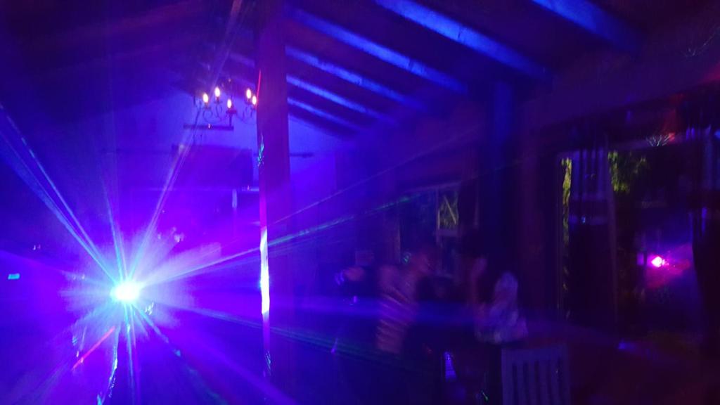 a beam of lights in a room with people at The Wild Farm Backpackers in Wilderness