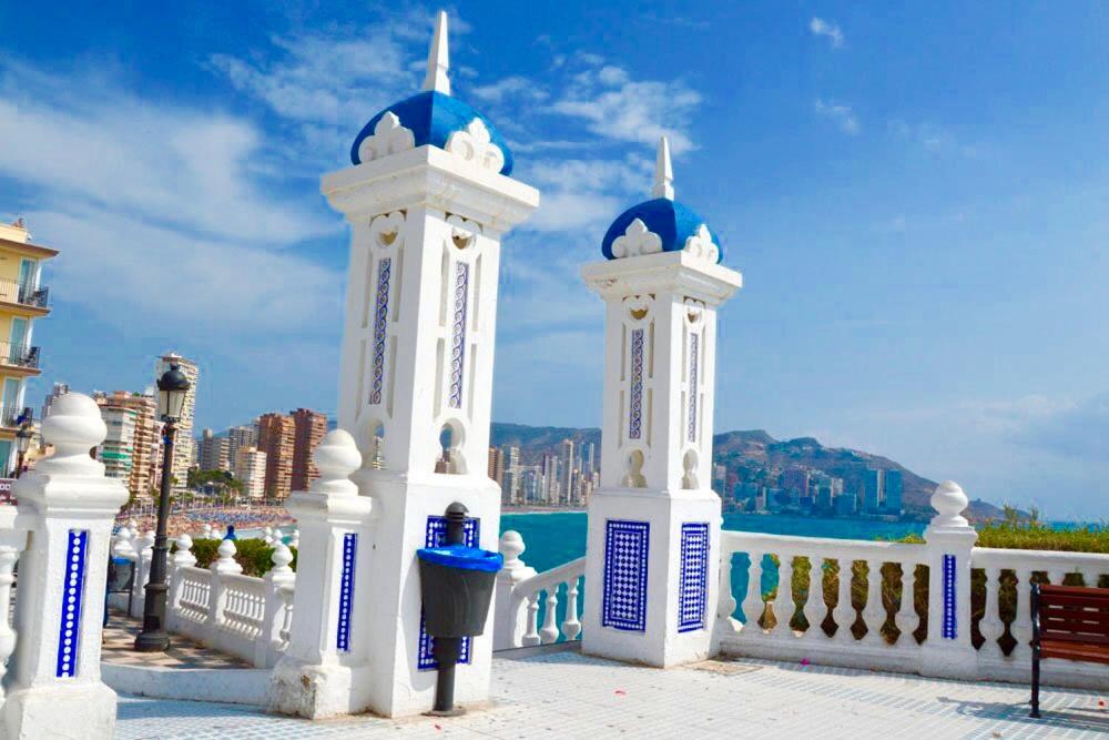 a white fence with two towers and a parking meter at Virginia of the sea in Benidorm