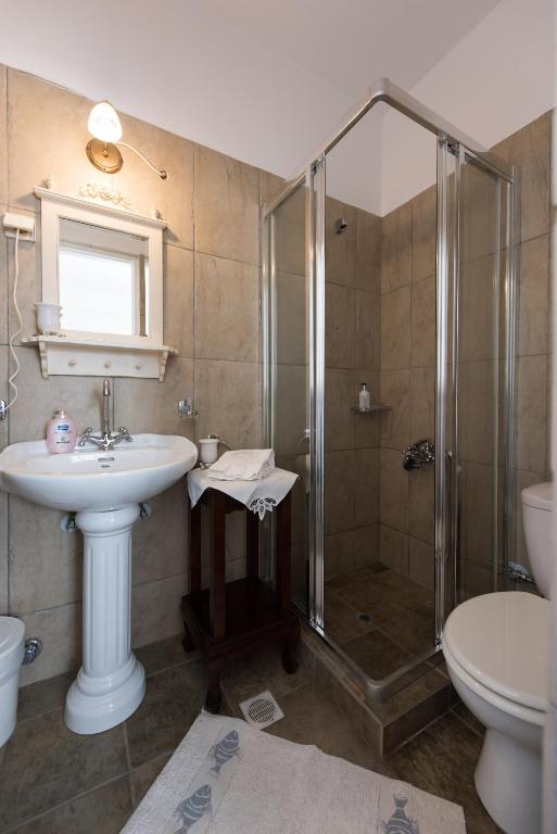 a bathroom with a sink and a shower at Villa Areto in Kamares
