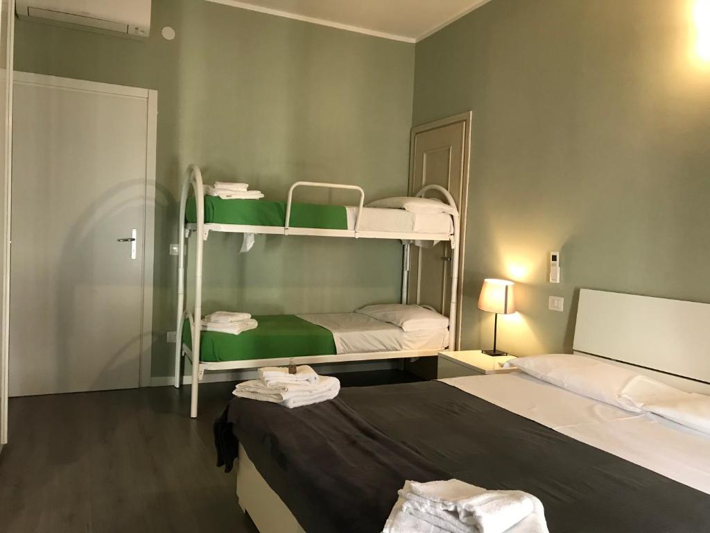 Postel nebo postele na pokoji v ubytování L'Arena Residence