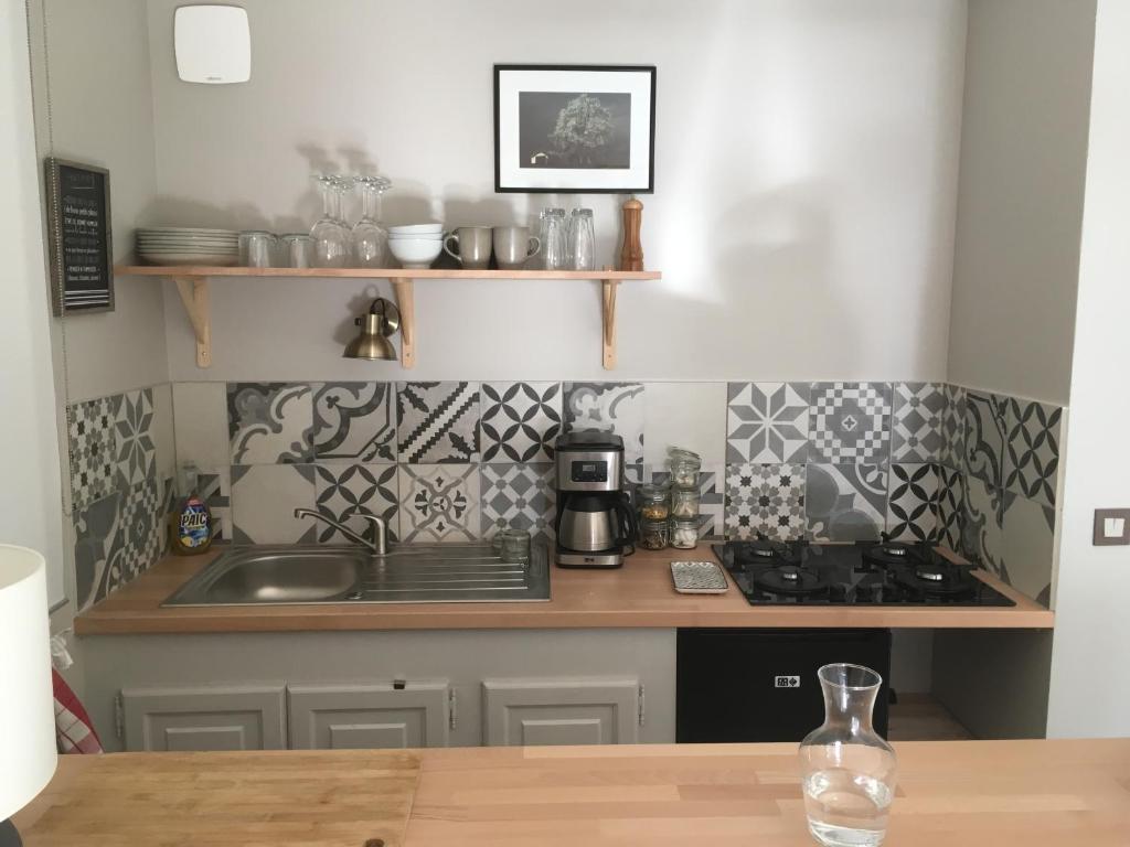 a kitchen with a sink and a counter top at Appartement Aline et Phil in Luz-Saint-Sauveur
