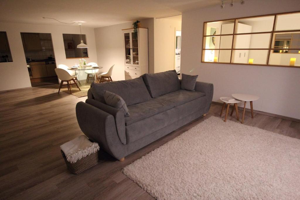 a living room with a gray couch and a table at Apartment Heddesheim in Heddesheim
