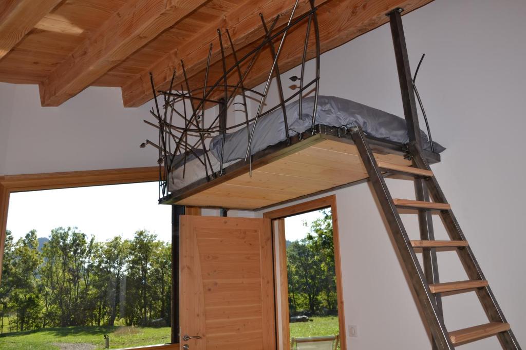 a room in a house under construction with a ladder at Bulle de Bois, écolodge insolite avec spa privatif au milieu des volcans - Bulles d&#39;Herbe in Queyrières