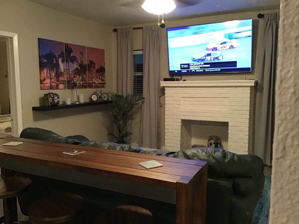 a living room with a couch and a flat screen tv at Modern 3/1 house close to Beaches and Midtown in Miami