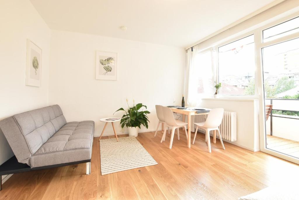 a living room with a couch and a table at Peaceful Studio Apartment near Center in Innsbruck