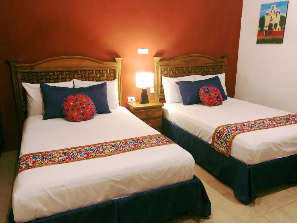 Postel nebo postele na pokoji v ubytování Hotel Real Colonial