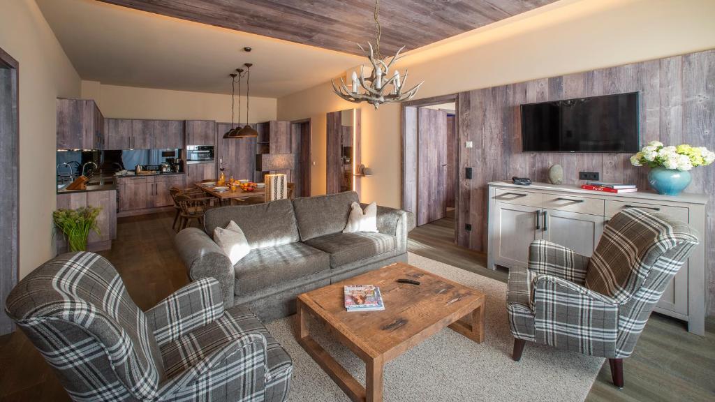 Televízia a/alebo spoločenská miestnosť v ubytovaní Mountain Spa Residences