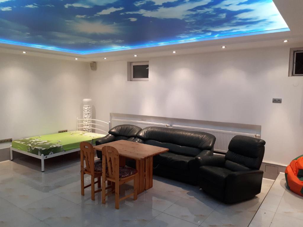 a living room with a couch and a table at Park Puscha Sauna Deluxe Apartment & Terrace in Kyiv