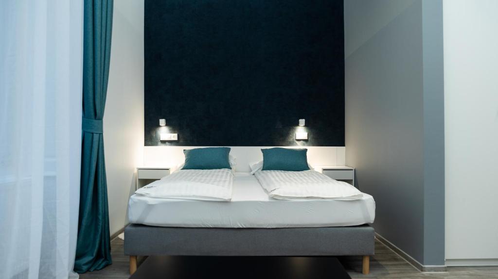 A bed or beds in a room at BpR Downtown Gemstone Apartments