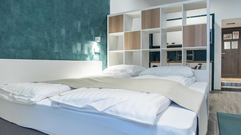 A bed or beds in a room at BpR Downtown Gemstone Apartments