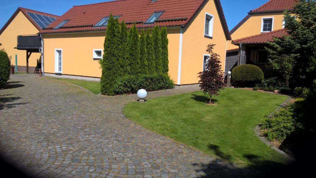 a house with a golf ball in the yard at A&C Bergen in Luckau