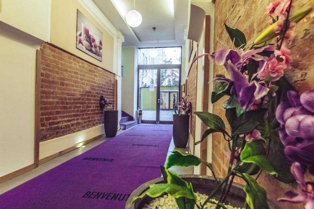 a hallway with purple carpeting and a brick wall at Aurellia Apartments in Vienna