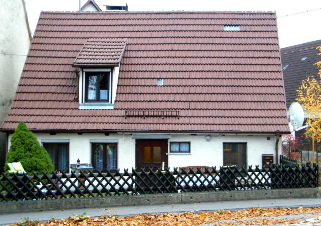 a white house with a red roof at Haus Lindenblick in Lonsee