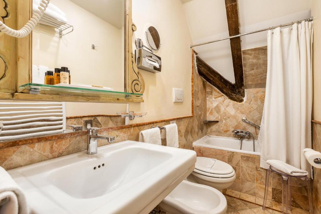 a bathroom with a sink and a toilet at Hotel Villa Laguna in Venice-Lido