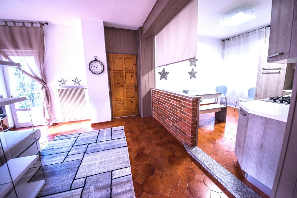 a kitchen with a brick wall and a table in a room at 1Dest - Lake & Family in Riva del Garda