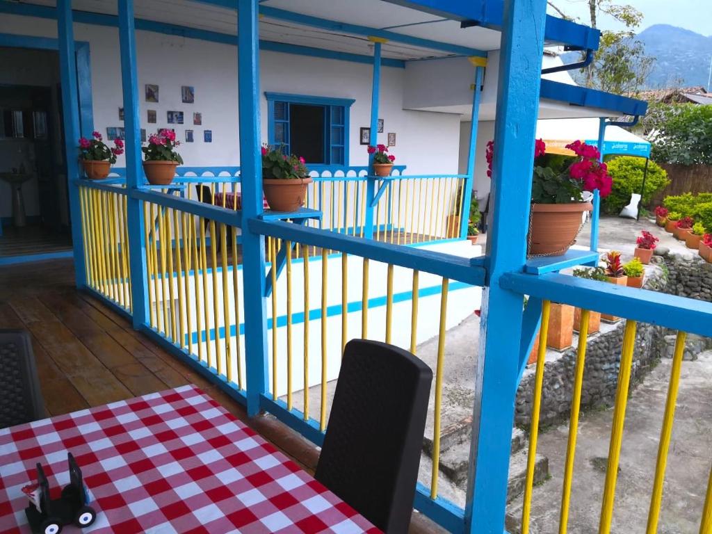a balcony with a table and a blue fence at Hotel Salento 1842 in Salento