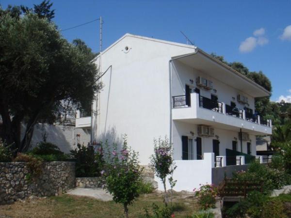 a white building with a balcony on top of it at Sea View in Paleokastritsa