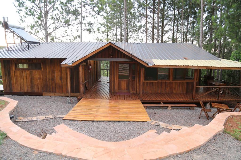 a large wooden cabin with a wooden deck at Piel de Timbó in Aristóbulo del Valle