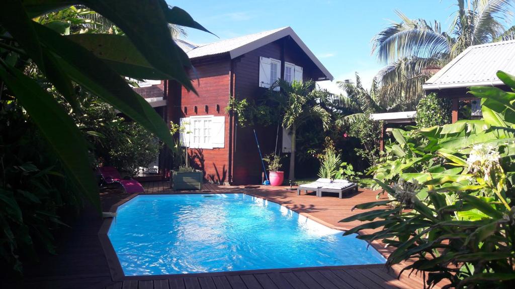 a swimming pool in front of a house at chambre d' hôte village sauvage in Langevin