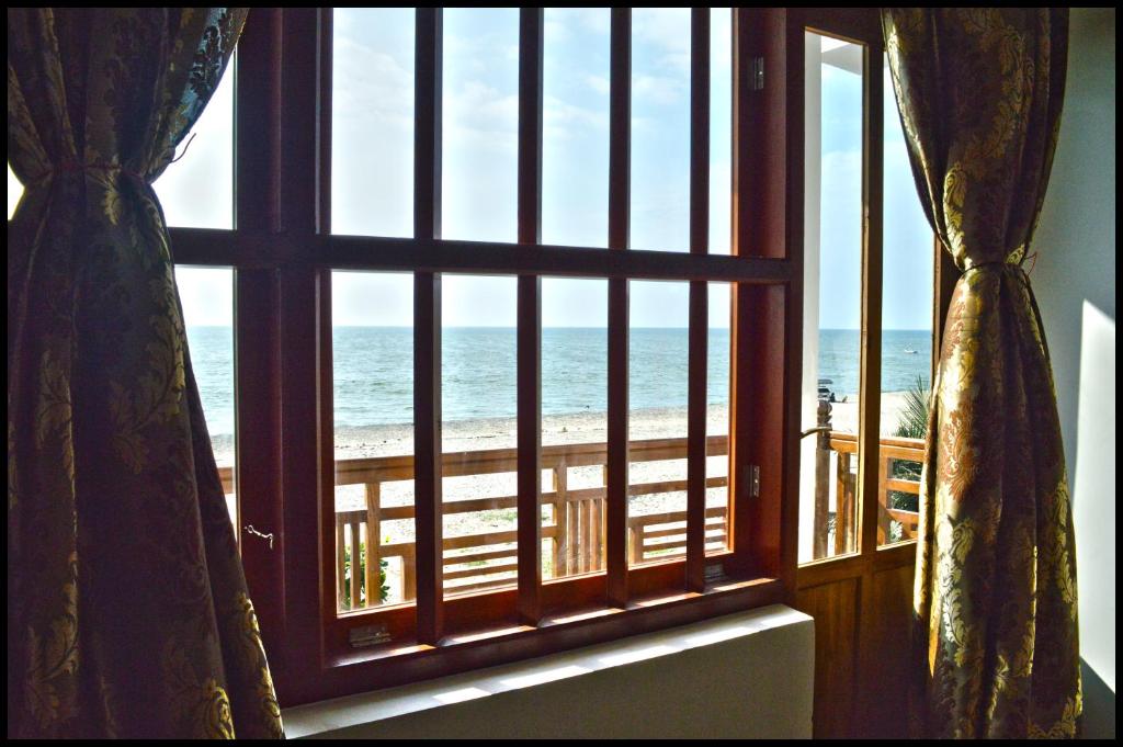 a window view of the ocean from a room at Neela Waters - Beach Home in Alleppey