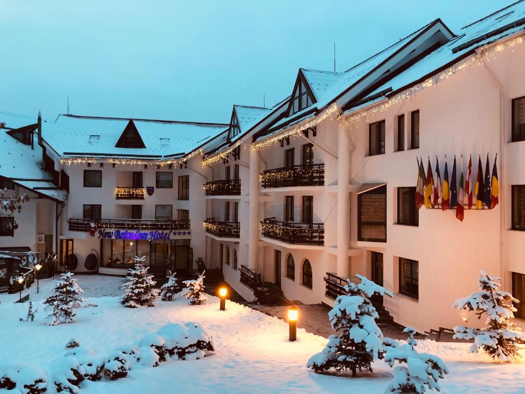 a courtyard of a hotel in the snow at Hotel Miruna - New Belvedere in Poiana Brasov
