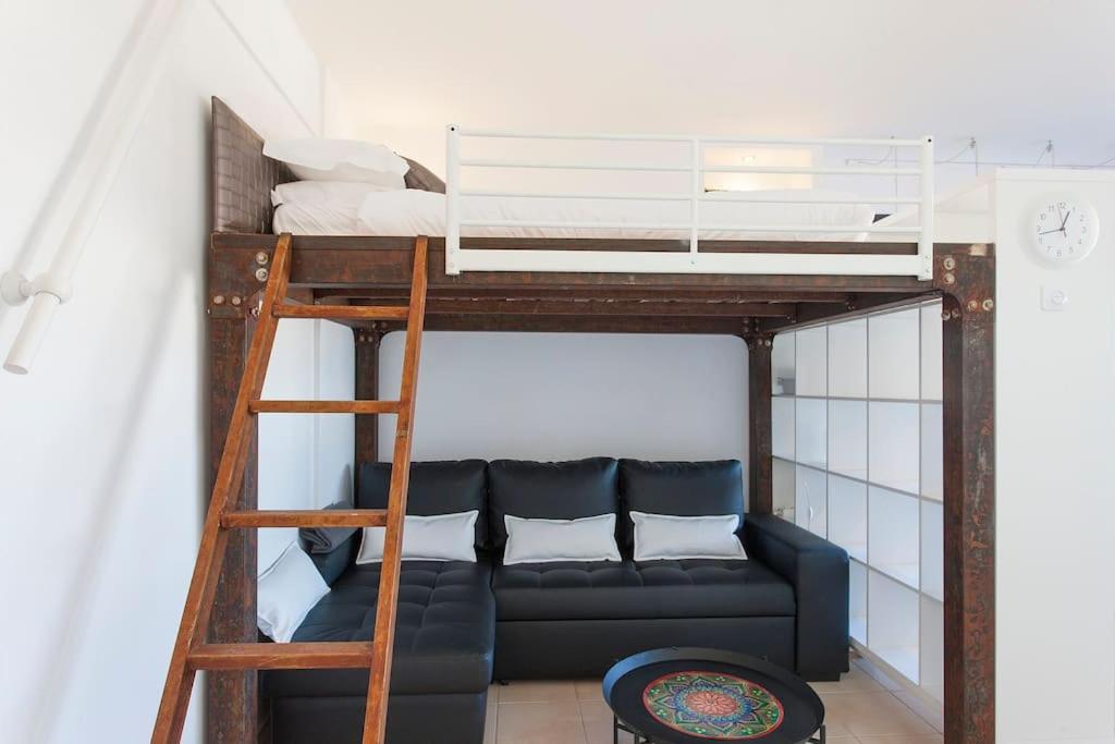 uma sala de estar com um beliche e um sofá em In Bed with Lisbon 5N na Amadora