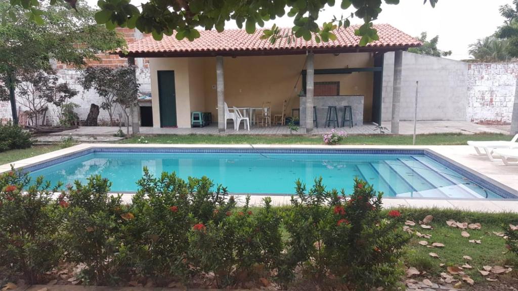 a swimming pool in front of a house at Toca do guaxinim in Itarema