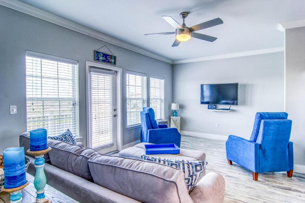 a living room with a couch and two blue chairs at Pathway 14820 in Padre Island