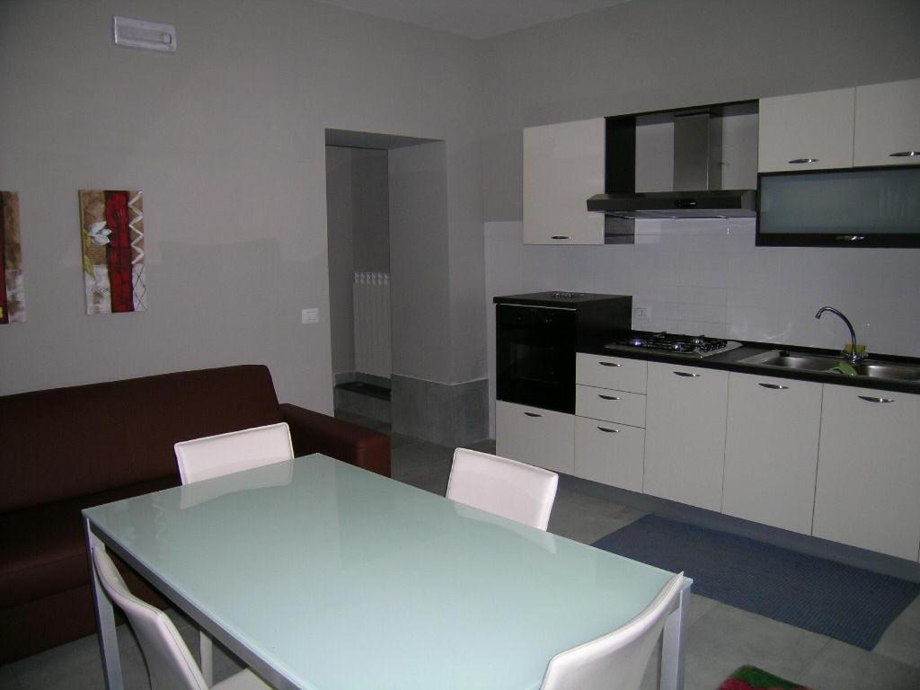 a kitchen with a white table and white chairs at Appartamento Ateleta via Colle Sisto in Ateleta