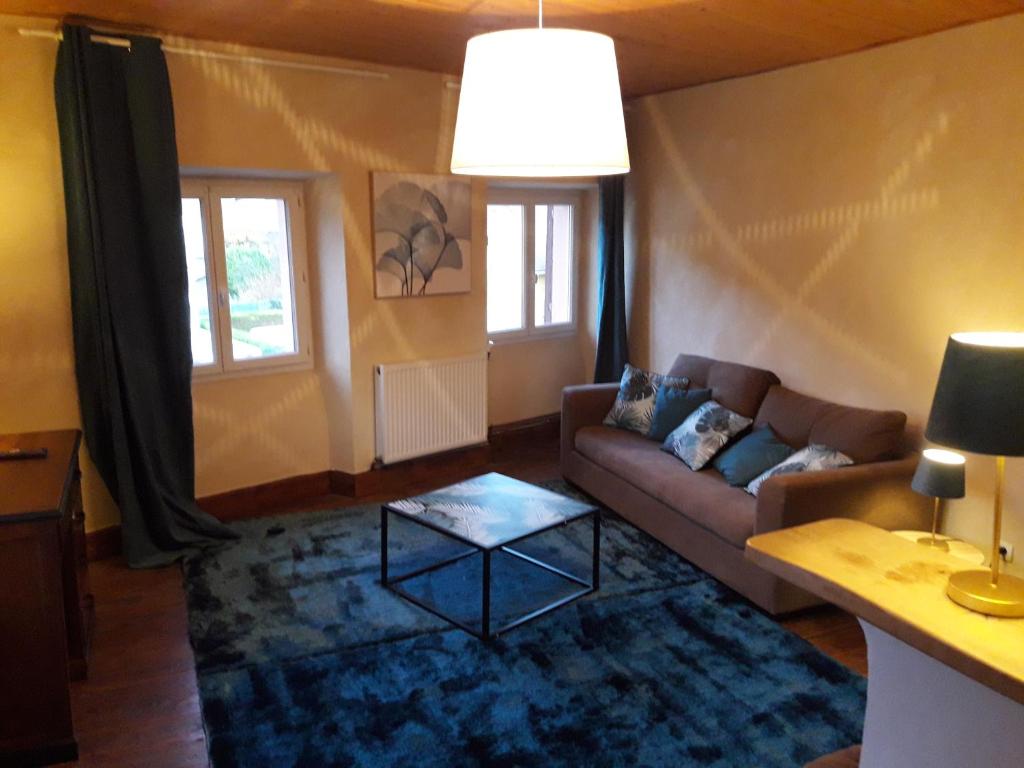 a living room with a couch and a table at Chambres d'hôtes Belle Occitane in Tarascon-sur-Ariège