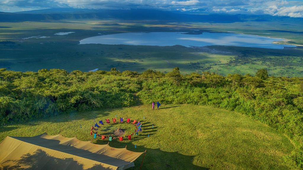 a group of people standing on top of a grassy hill at Pakulala Safari Camp - Ngorongoro in Ngorongoro