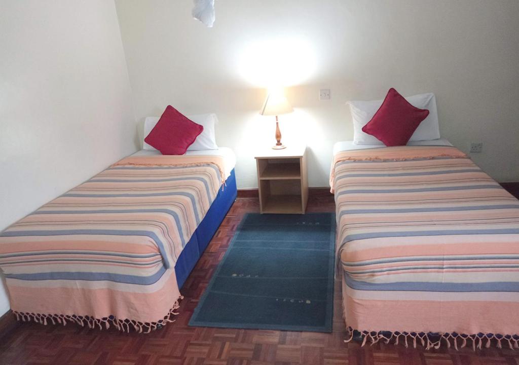 Postel nebo postele na pokoji v ubytování Chester Hotel and Suites Nairobi, City Centre CBD