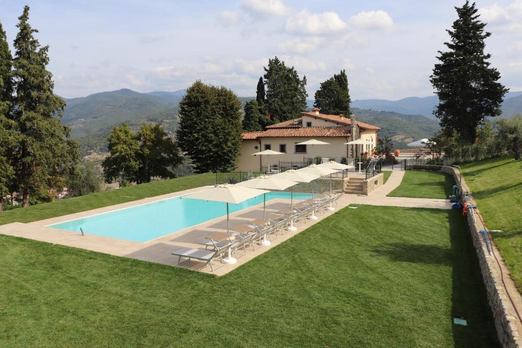 einen externen Blick auf eine Villa mit einem Pool in der Unterkunft Borgo di Villa Cellaia Resort & SPA in Dicomano