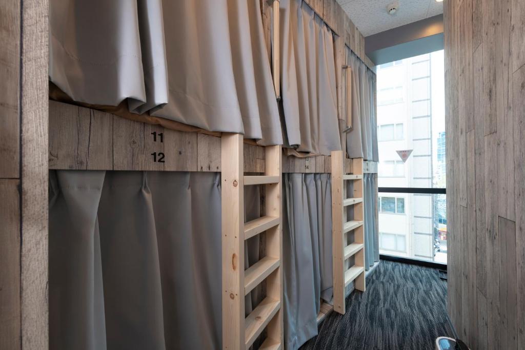 Postel nebo postele na pokoji v ubytování bnb+ Kanda Terrace Ogawamachi