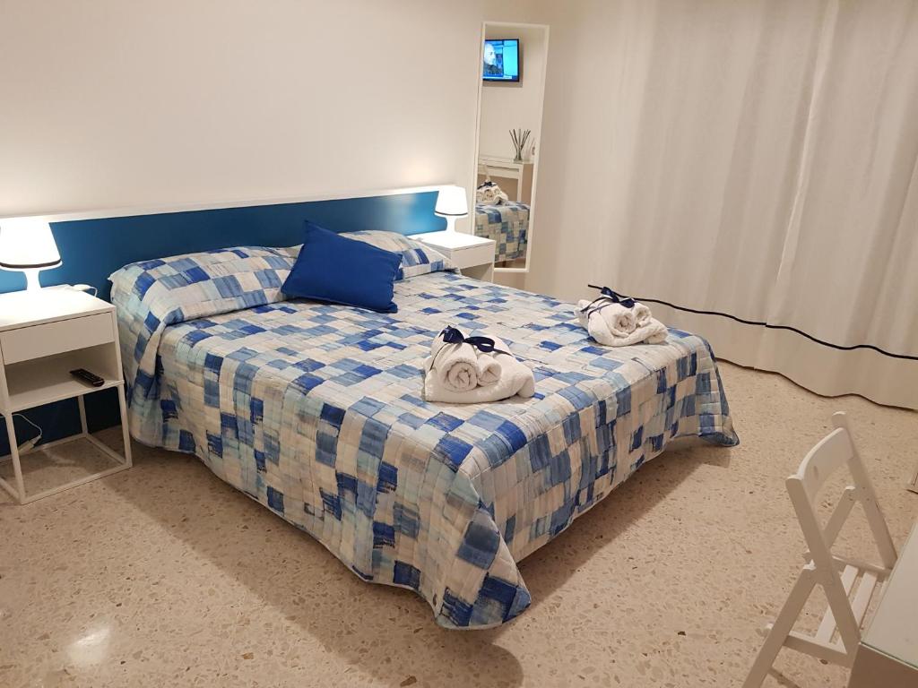 a bedroom with a bed with towels on it at Barone Blu in Salerno