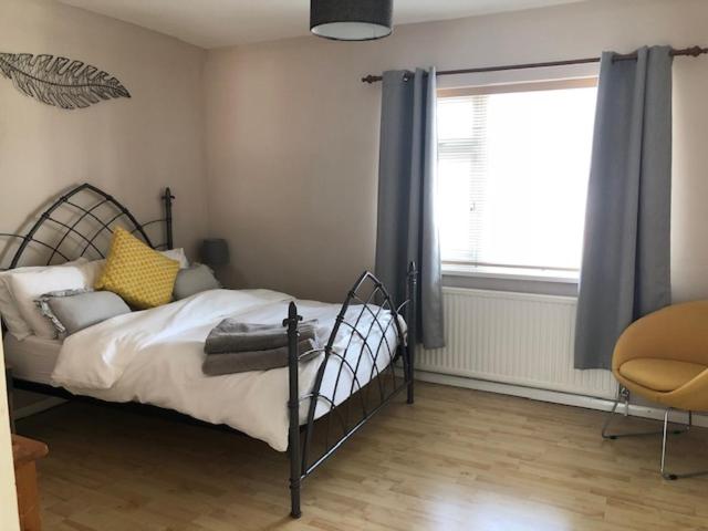 a bedroom with a bed and a window and a chair at Comfortable House in Warwick in Warwick