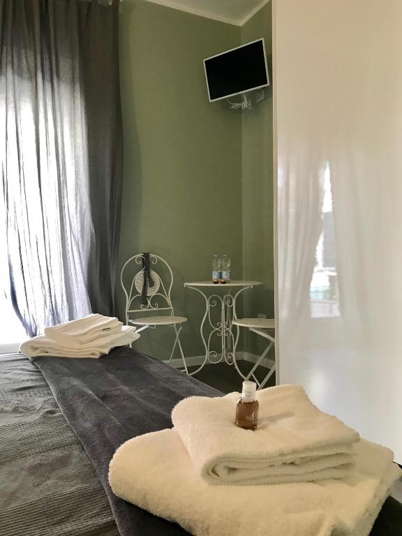 Postel nebo postele na pokoji v ubytování L'Arena Residence