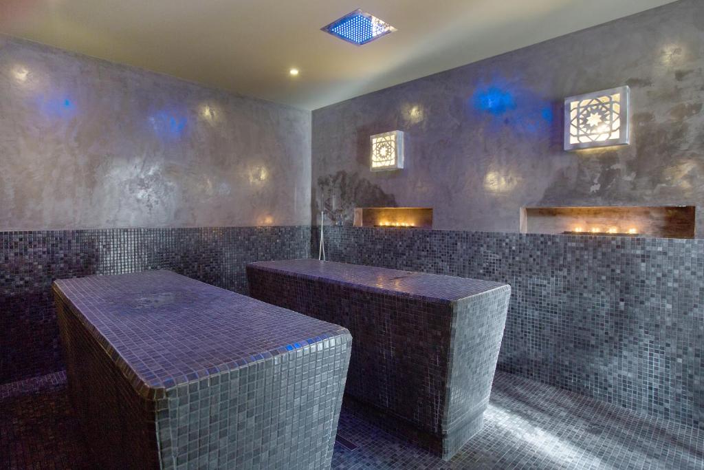 a bar with two tables in a room with tiles at Ama Islantilla Resort in Islantilla