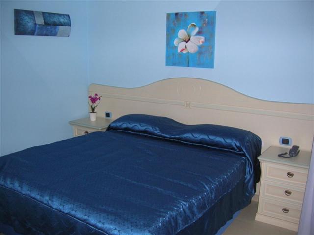 - une chambre bleue avec un lit et une commode avec une couverture bleue dans l'établissement MOTEL 24H, à Aversa