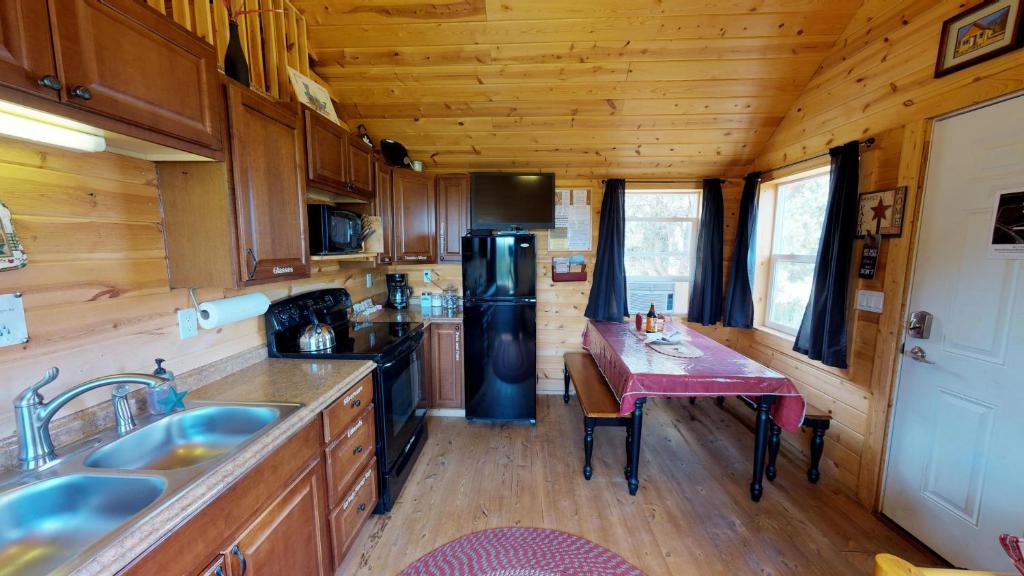 a kitchen with a small table in a tiny house at White Pine Cabin by Canyonlands Lodging in Monticello