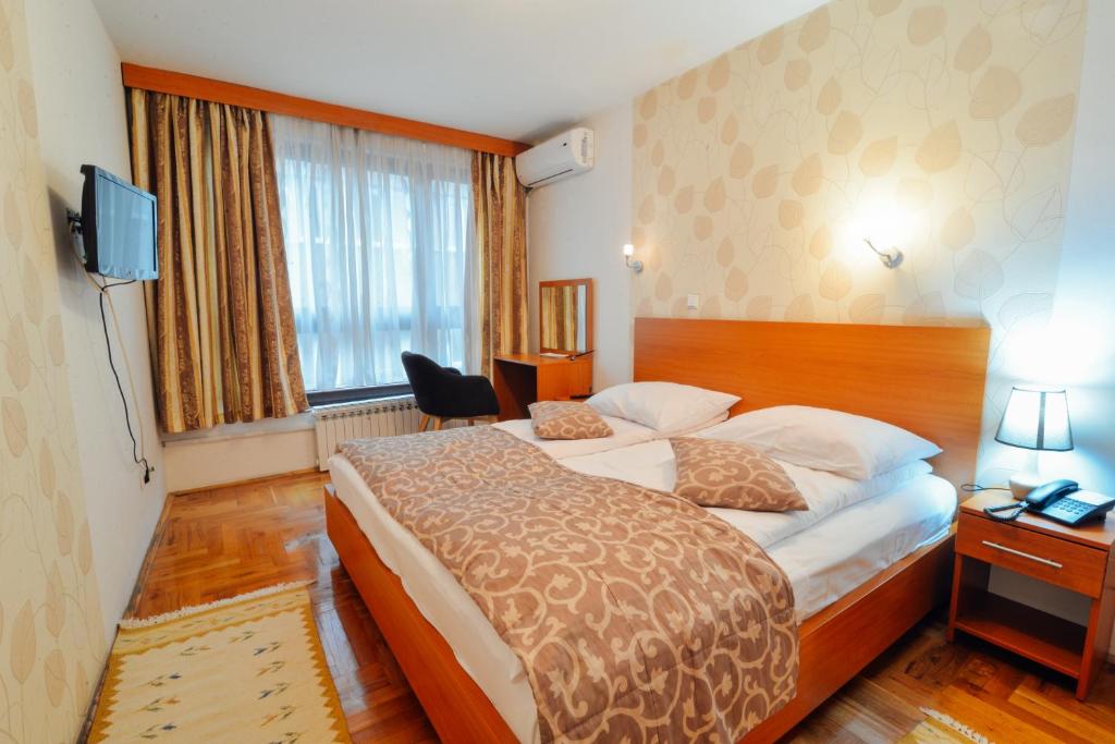 a hotel room with a bed and a television at Hotel Mod in Sarajevo