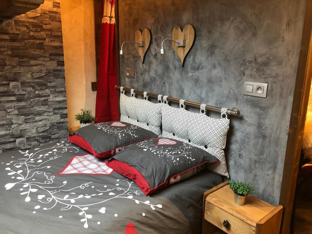 une chambre avec un lit avec deux oreillers dessus dans l'établissement Le Cocoon de Sarah, à Chamonix-Mont-Blanc