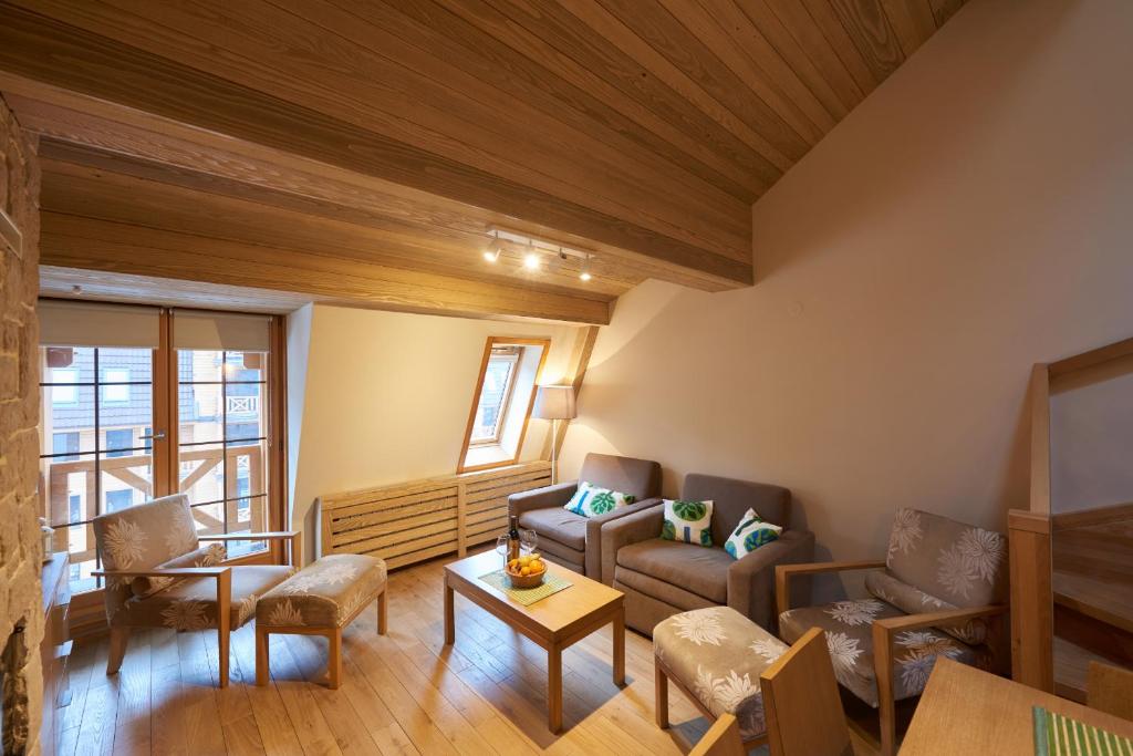 a living room with a couch and a table at Apartment 411 Vucko in Jahorina