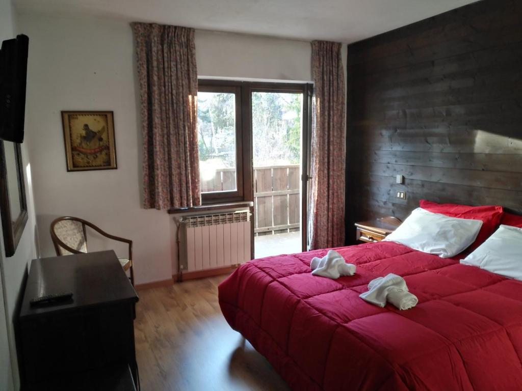 Postel nebo postele na pokoji v ubytování Hotel I Larici