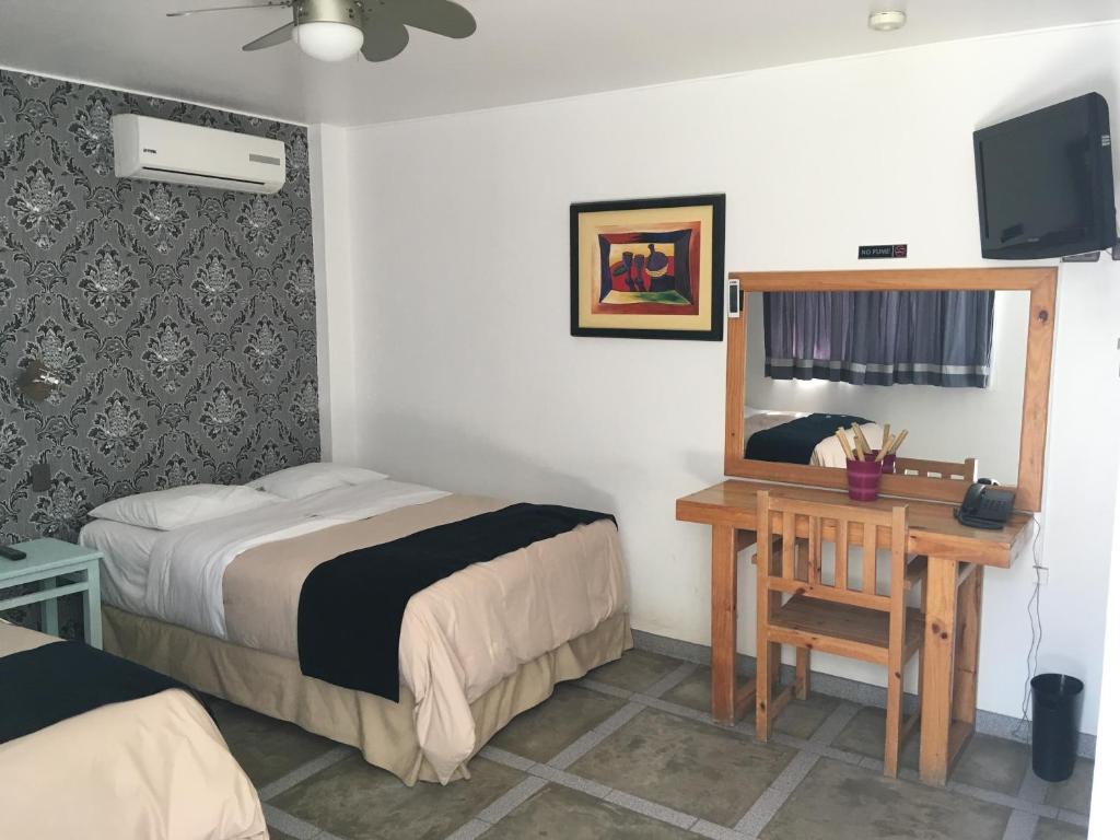 Postel nebo postele na pokoji v ubytování Hotel Villa Jazmin