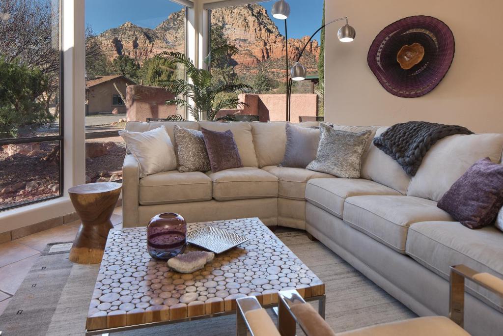 a living room with a couch and a table at Luxurious Red Rock Vista Villa in Sedona