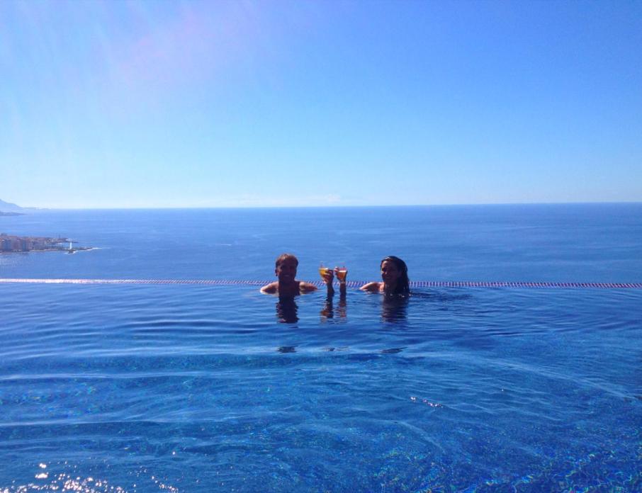 two people in the water in a swimming pool at Villa OCEAN Infinity heated pool optional in Santa Úrsula