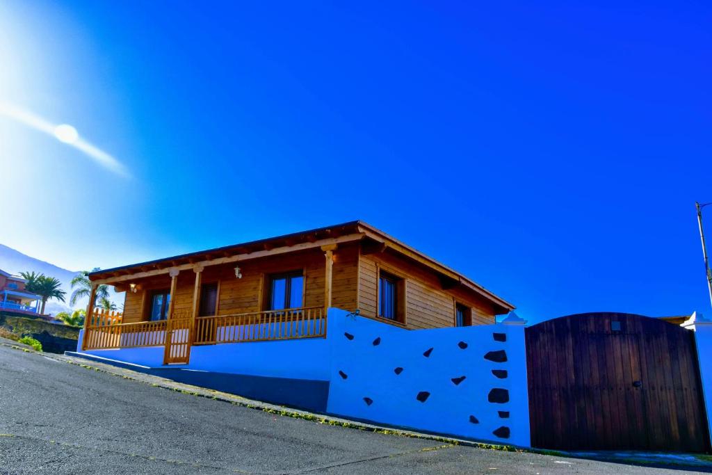 a house with a blue fence in front of it at Chalet Las Viñas 2 in Icod de los Vinos