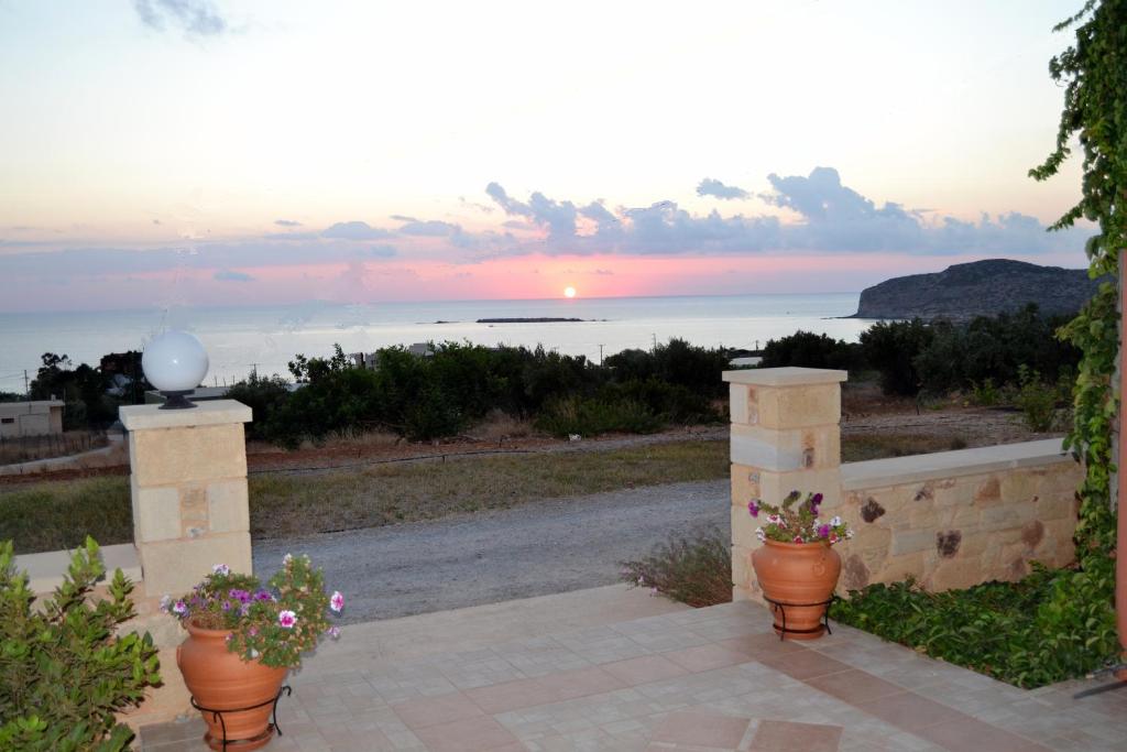 a patio with two flower pots and a view of the ocean at Romantica Apartments in Falasarna