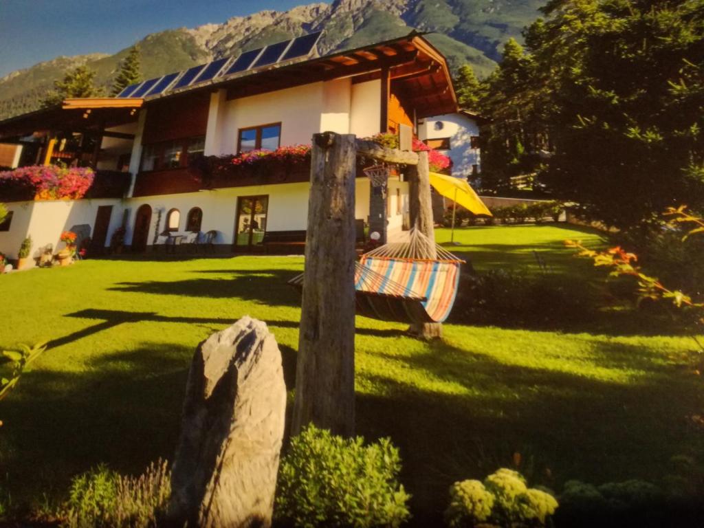 a house with a hammock in front of it at Ferienwohnung Fringer in Obtarrenz